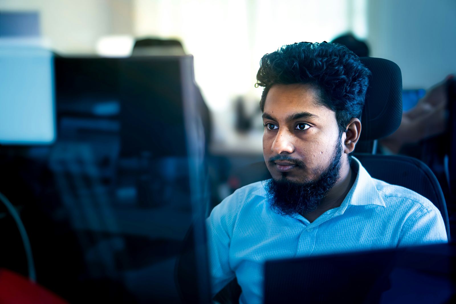 Engineer focused on a monitor while working